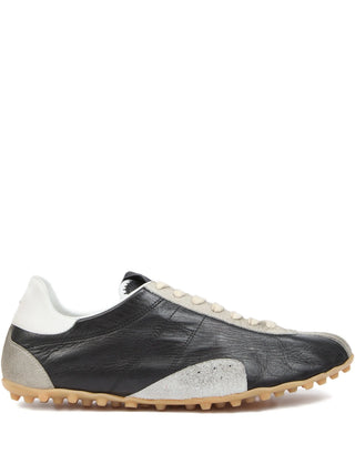 Black and white sneaker with a textured sole by Maison Margiela