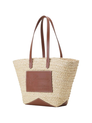 Woven straw tote bag with brown leather accents 