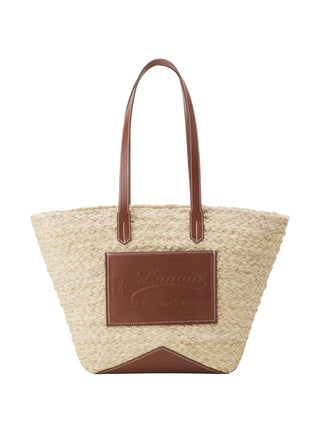 Woven handbag with brown leather accents and a visible brand logo