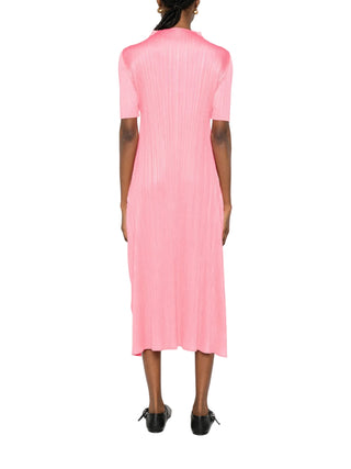 Person wearing a pink dress by Pleats Please Issey Miyake