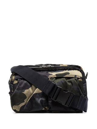 Camouflage-patterned bag with a black strap by Porter Yoshida and Co. 