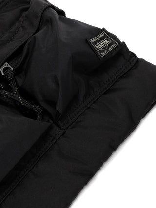 Close-up of a black jacket with a brand logo by Porter-Yoshida and Co. 