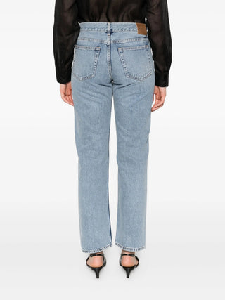 Light blue jeans with pockets worn by a person 