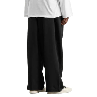 Person wearing a white top and black wide-leg pants by Y-3