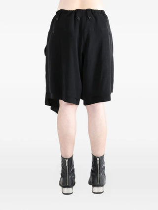 Black shorts worn with black boots 