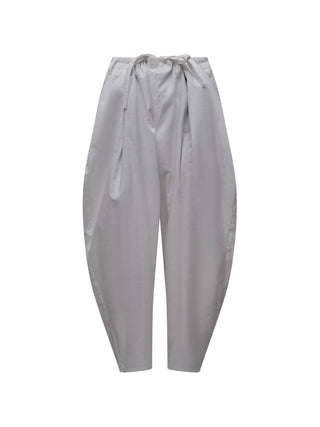 White pants with a tie waist and pleats by Yohji Yamamoto
