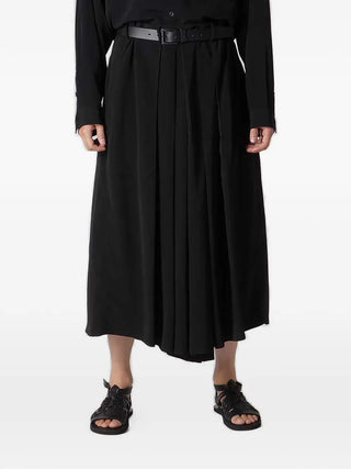 Person wearing a black outfit with a belt by Yohji Yamamoto