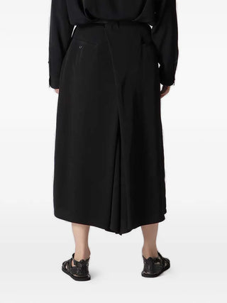 Person wearing a black trousers by Yohji Yamamoto
