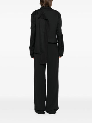 Black suit worn by a person by Yohji Yamamoto